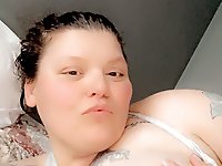 The woman is posing naked for a photo session