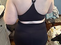 A woman in the nude is riding a horse and wearing a cowgirl hat.