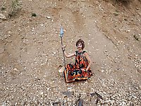 With spear wearing in colorful dress